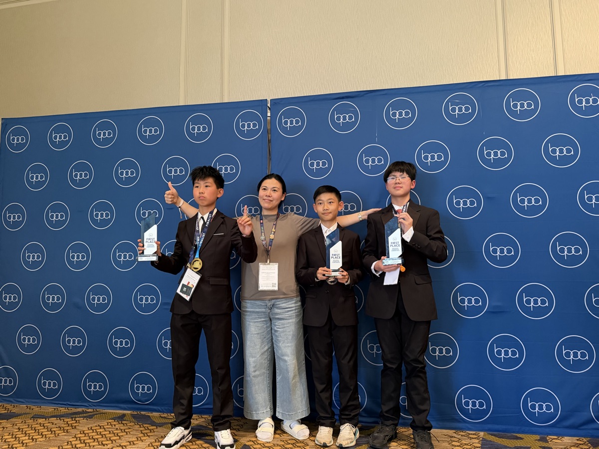 Beyond Young team posing with First Place trophies in front of the BPA backdrop