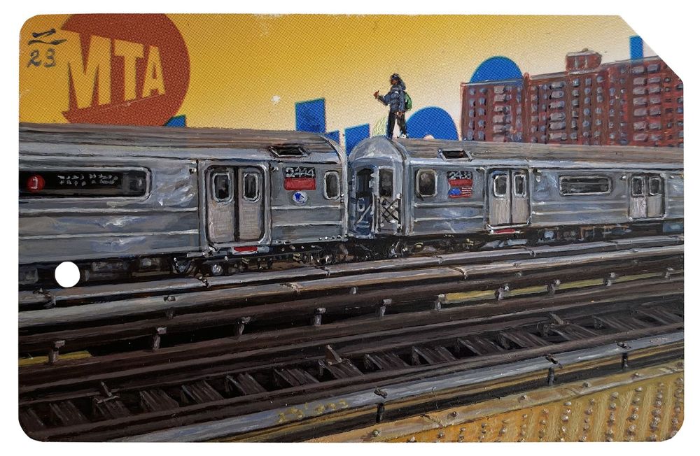 A tiny painted figure stands on the roof of a silver elevated subway train, painted over a yellow MetroCard